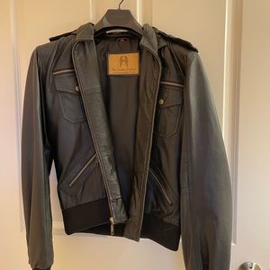 Woman's black leather short jacket with zip off hood.